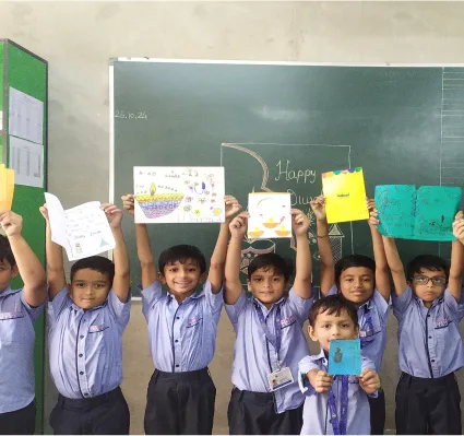 Students Displaying Handmade Diwali Cards in Classroom Activity