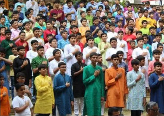 Students in Traditional Attire Taking Pledge During School Ceremony
