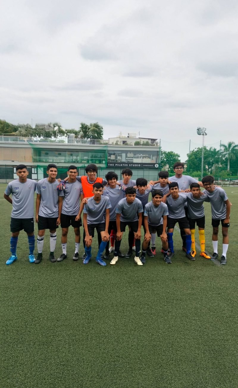 Student Football Team Group Photo on Turf Field