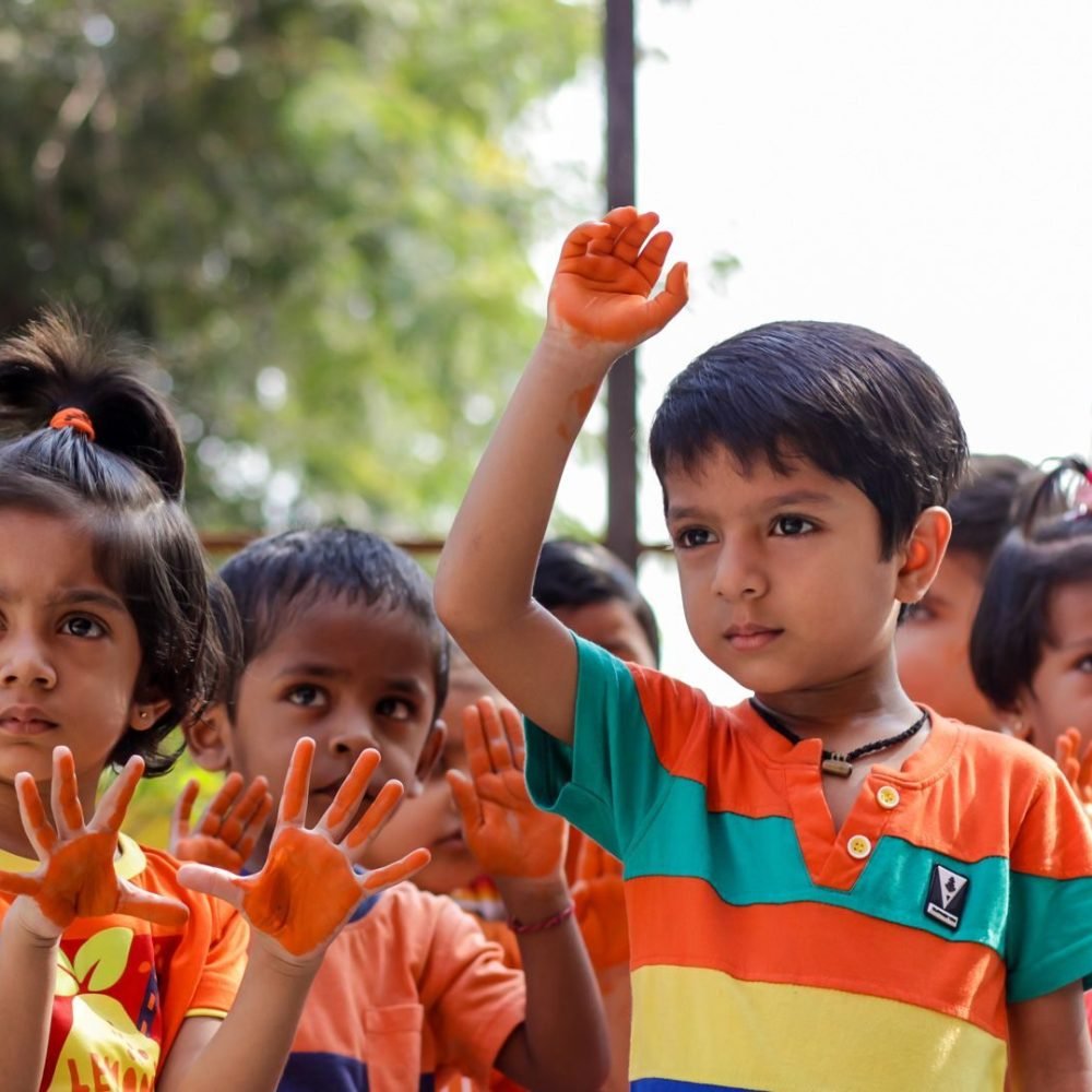 Children Participating in Hand Painting Activity