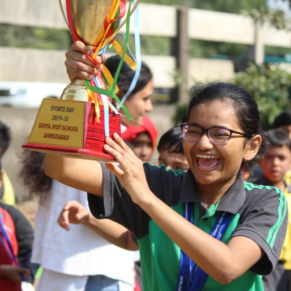 Student Celebrating Trophy Victory at School Sports Day