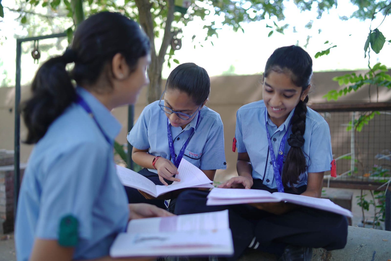 Schoolgirls Studying Together in Outdoor Garden