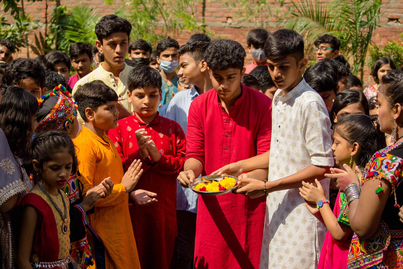 Students Performing Aarti Ritual in Traditional Attire