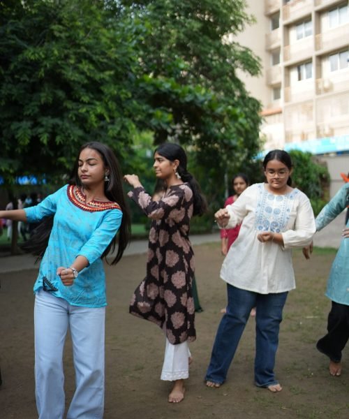 Girls Dancing Outdoors in Traditional and Casual Outfits