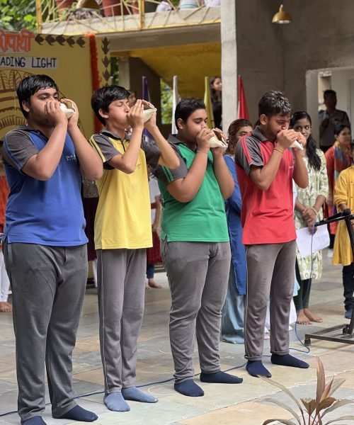 Students Blowing Conch Shells at School Event